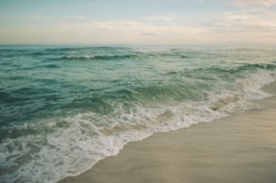 a beach with waves coming in to shore