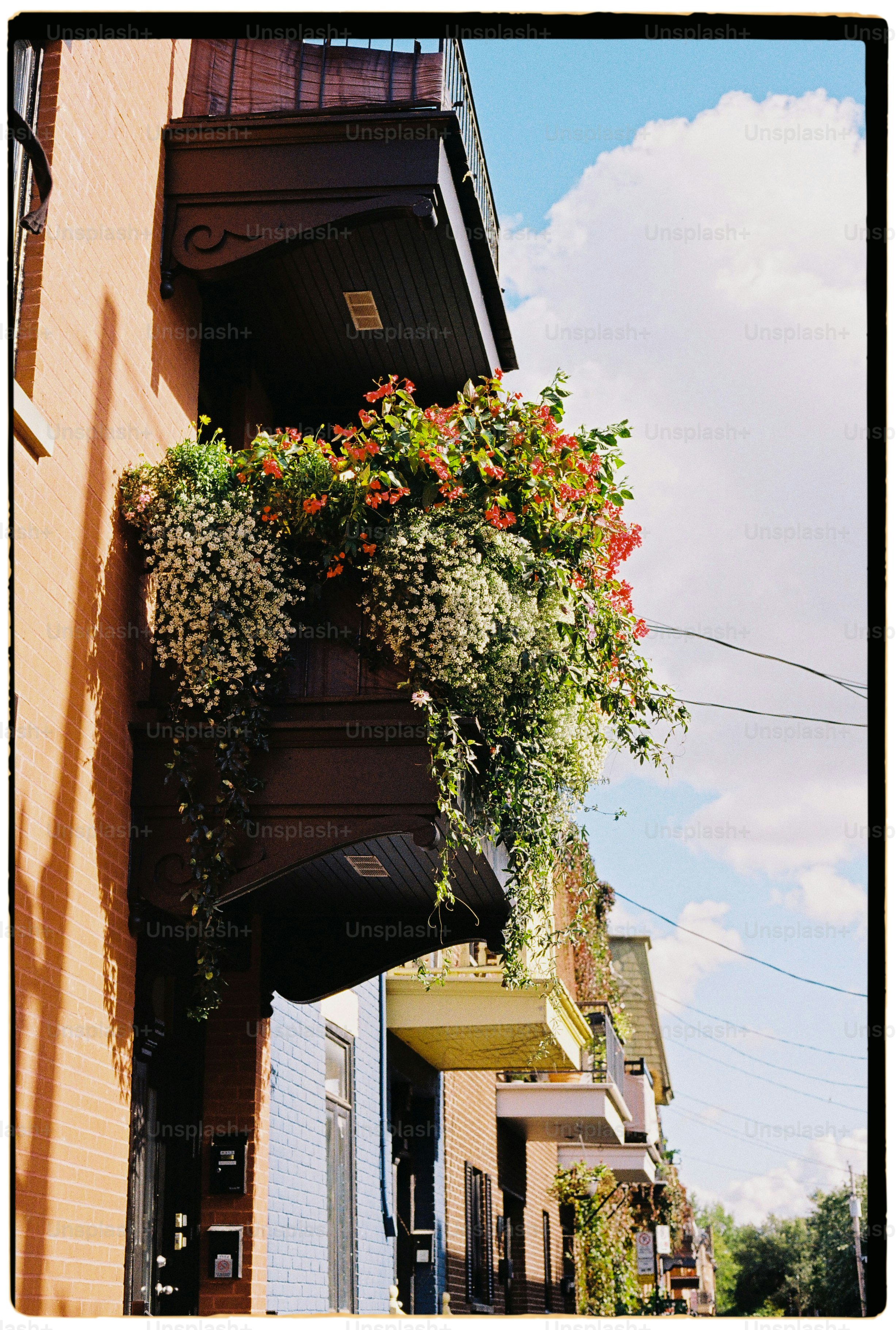 a building with a bunch of flowers hanging from it's side