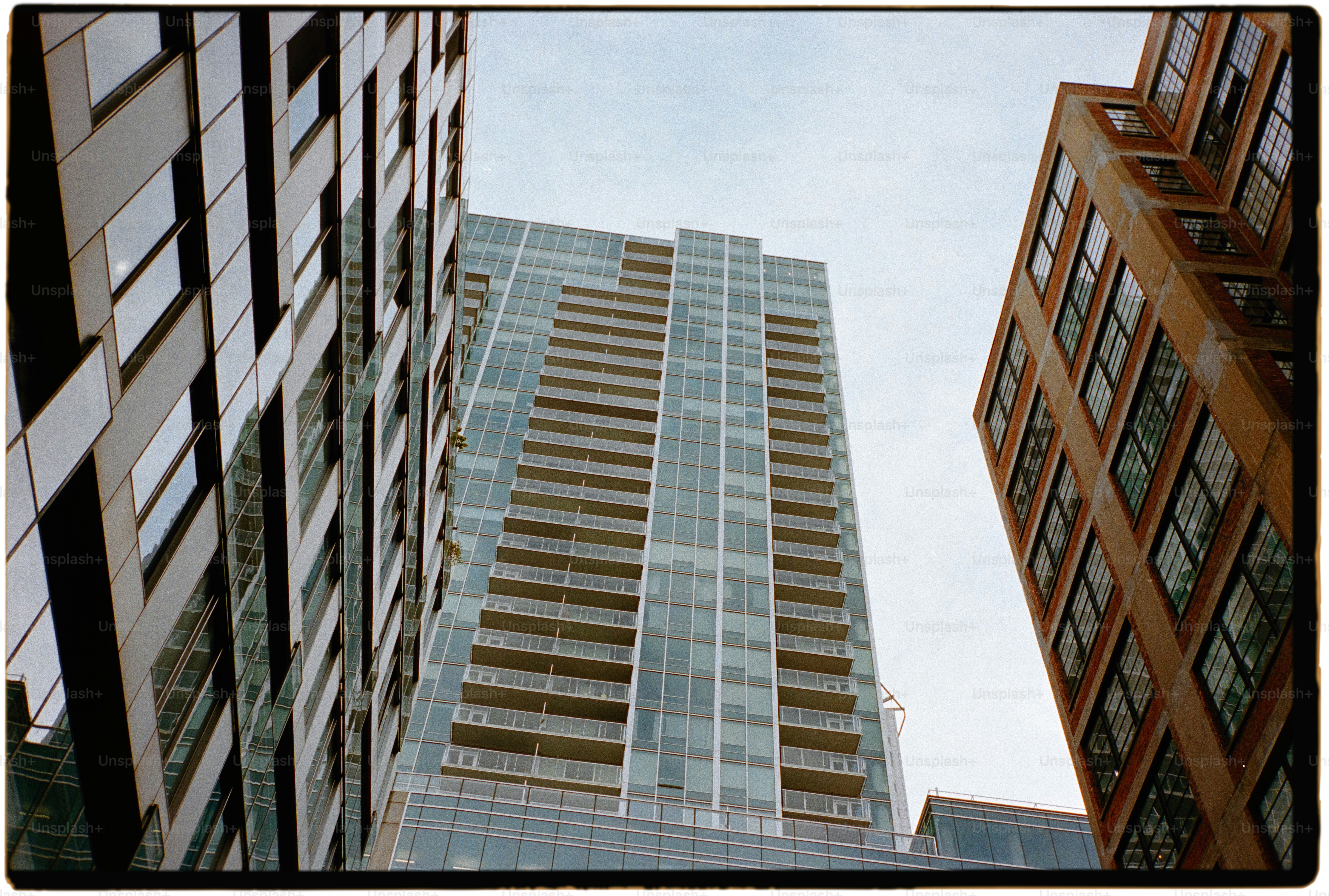 a tall building with lots of windows next to other buildings