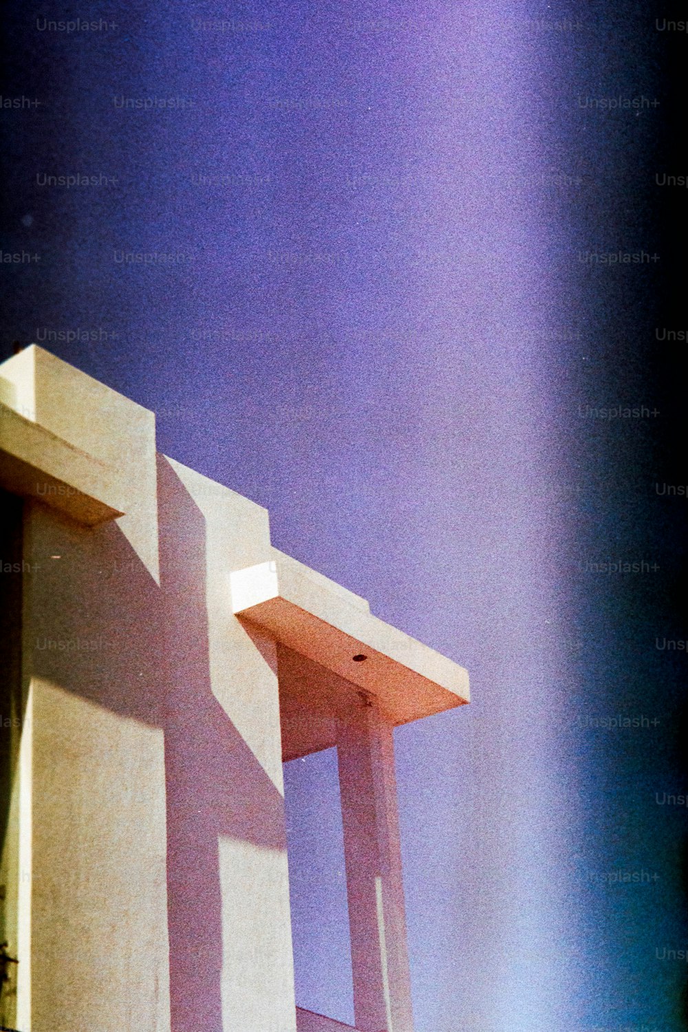 a tall white chair sitting next to a building