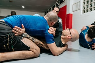 a group of men wrestling in a gym