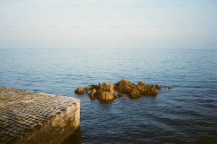 a rock outcropping in the middle of the ocean