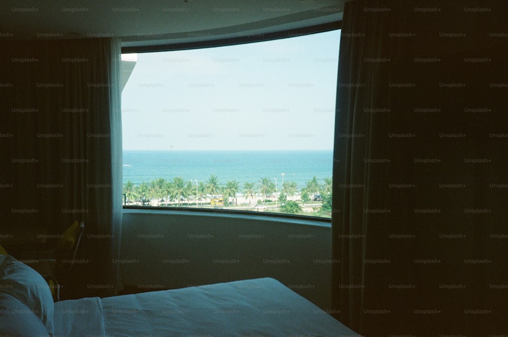 a bedroom with a view of the ocean