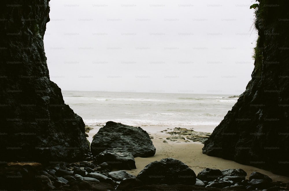 a view of the ocean through two rocks