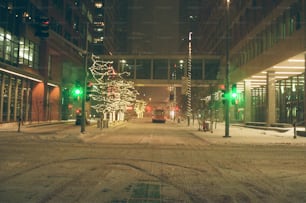 a snowy city street with a green traffic light