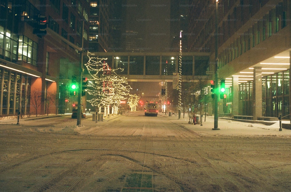 a snowy city street with a green traffic light