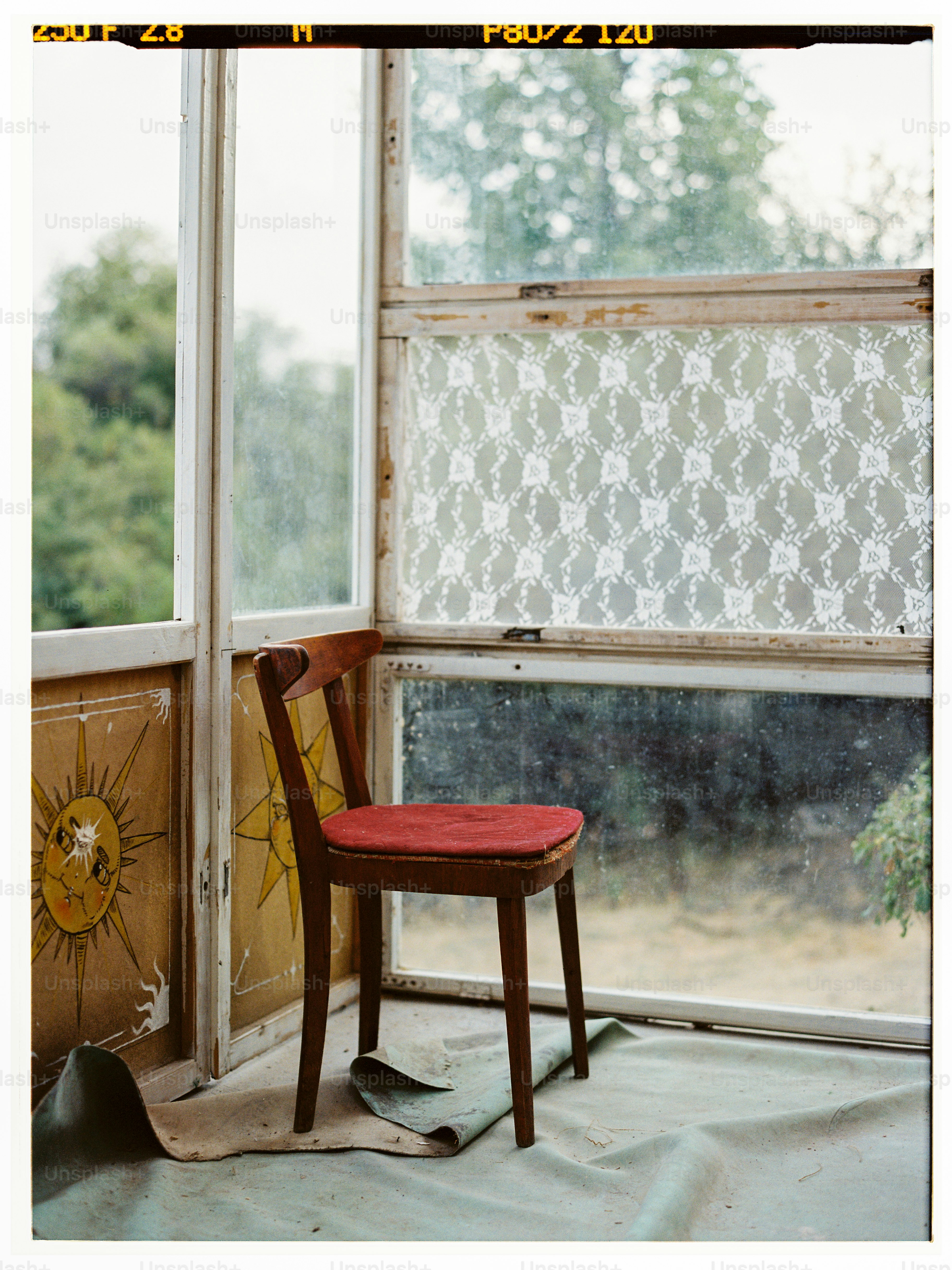 a wooden chair sitting in front of a window