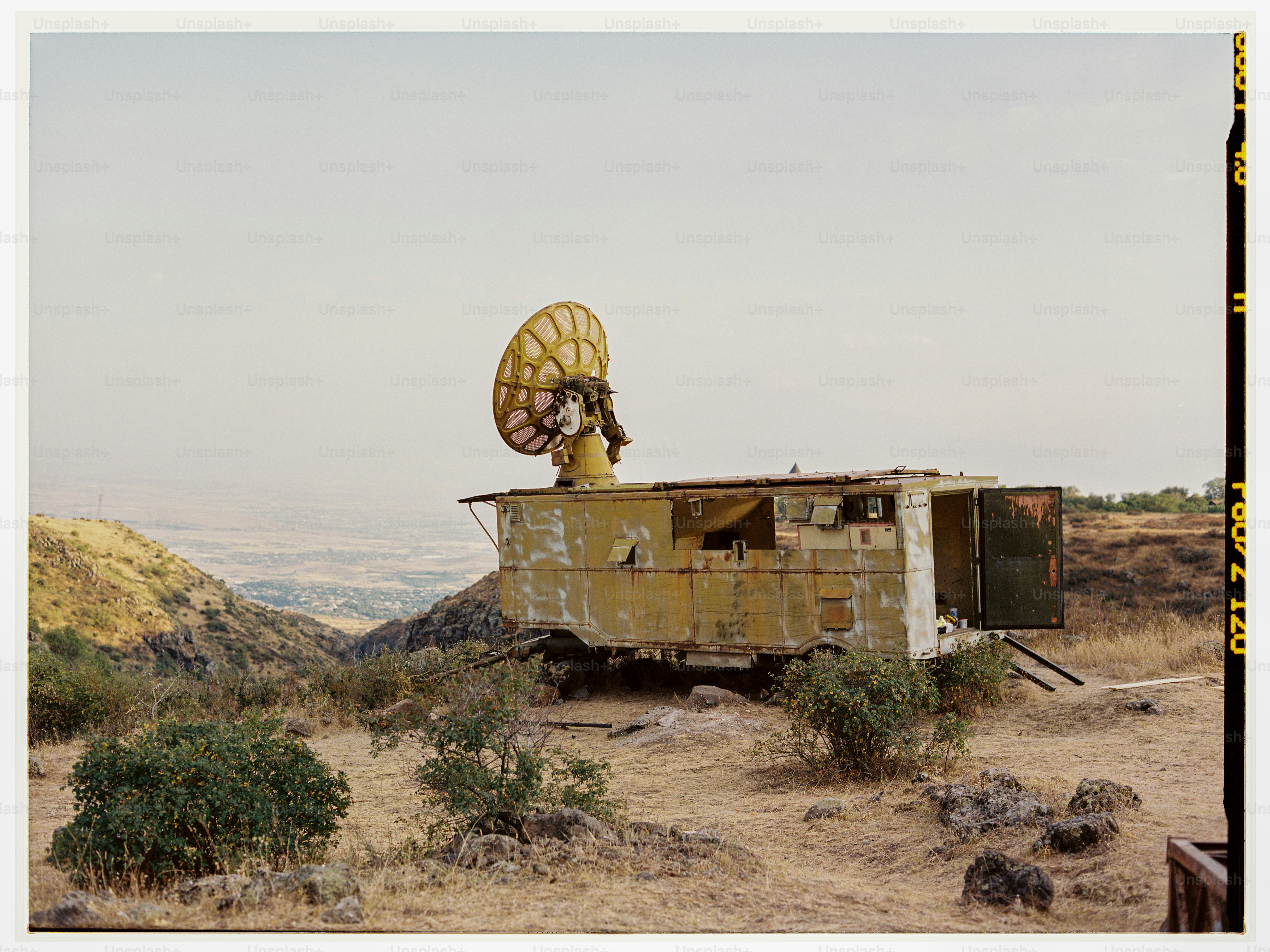 an old truck with a satellite dish on top of it