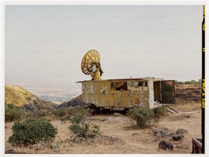 an old truck with a satellite dish on top of it