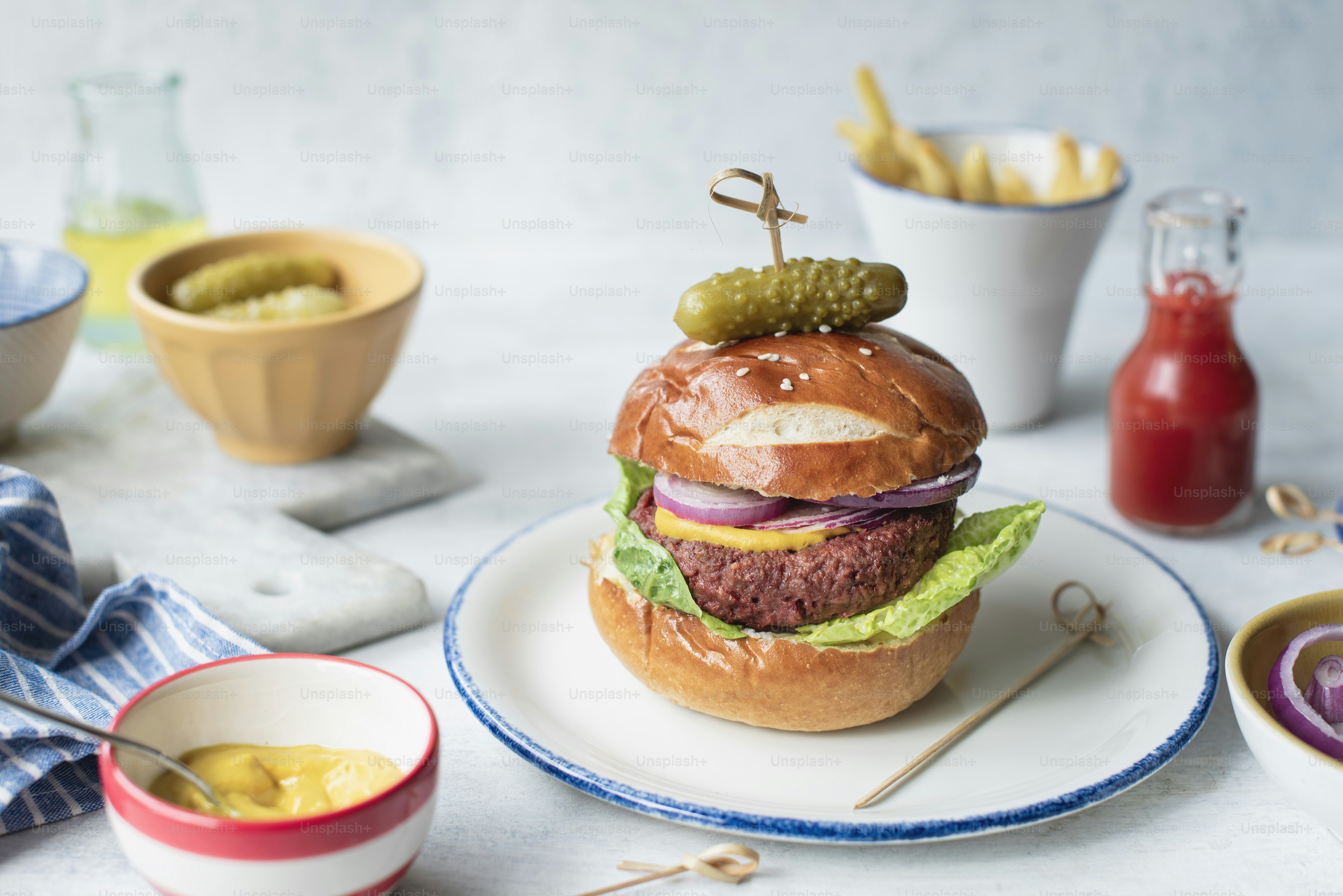 a hamburger on a plate with a pickle on top