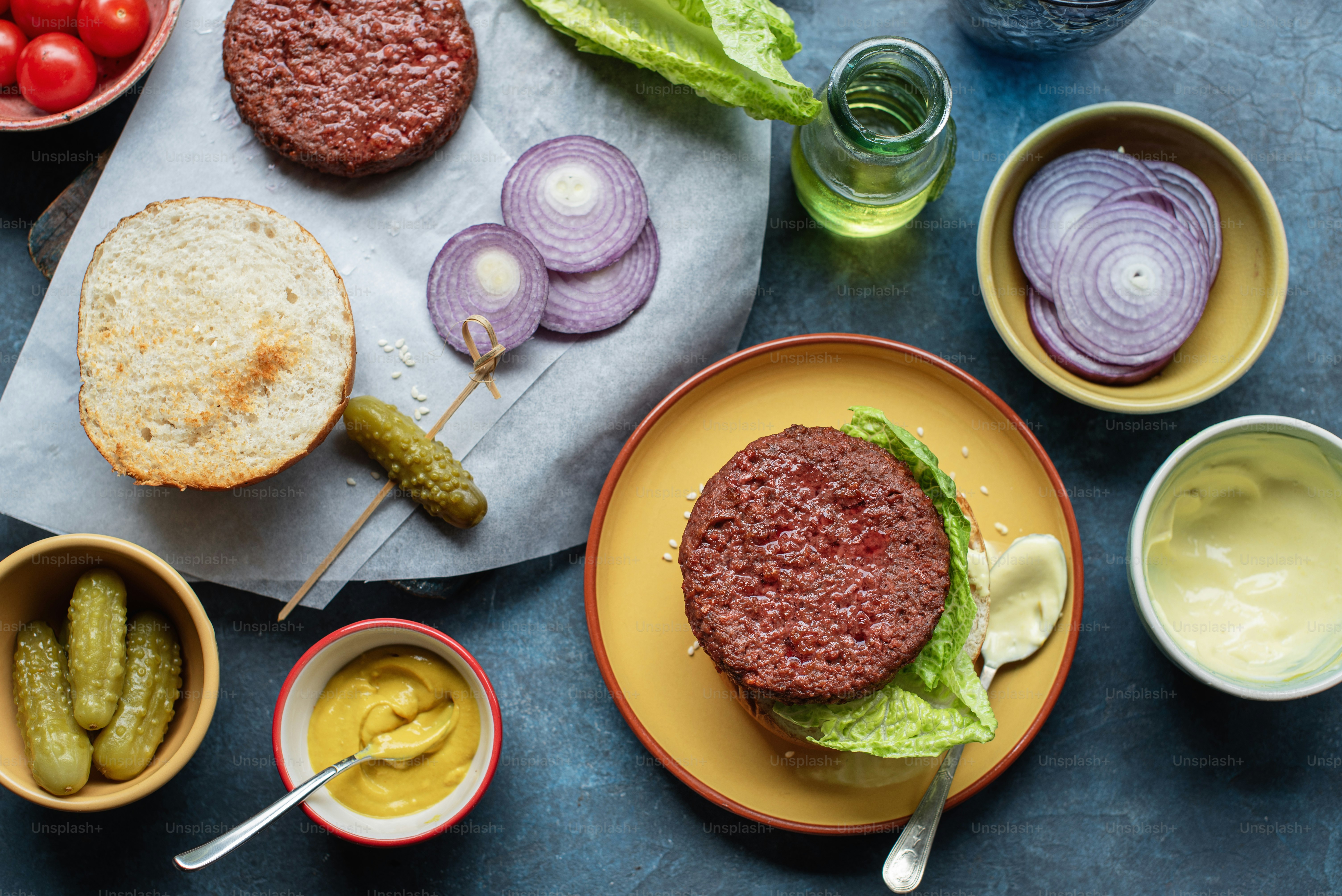 a hamburger with lettuce, tomatoes, pickles, pickles, pick