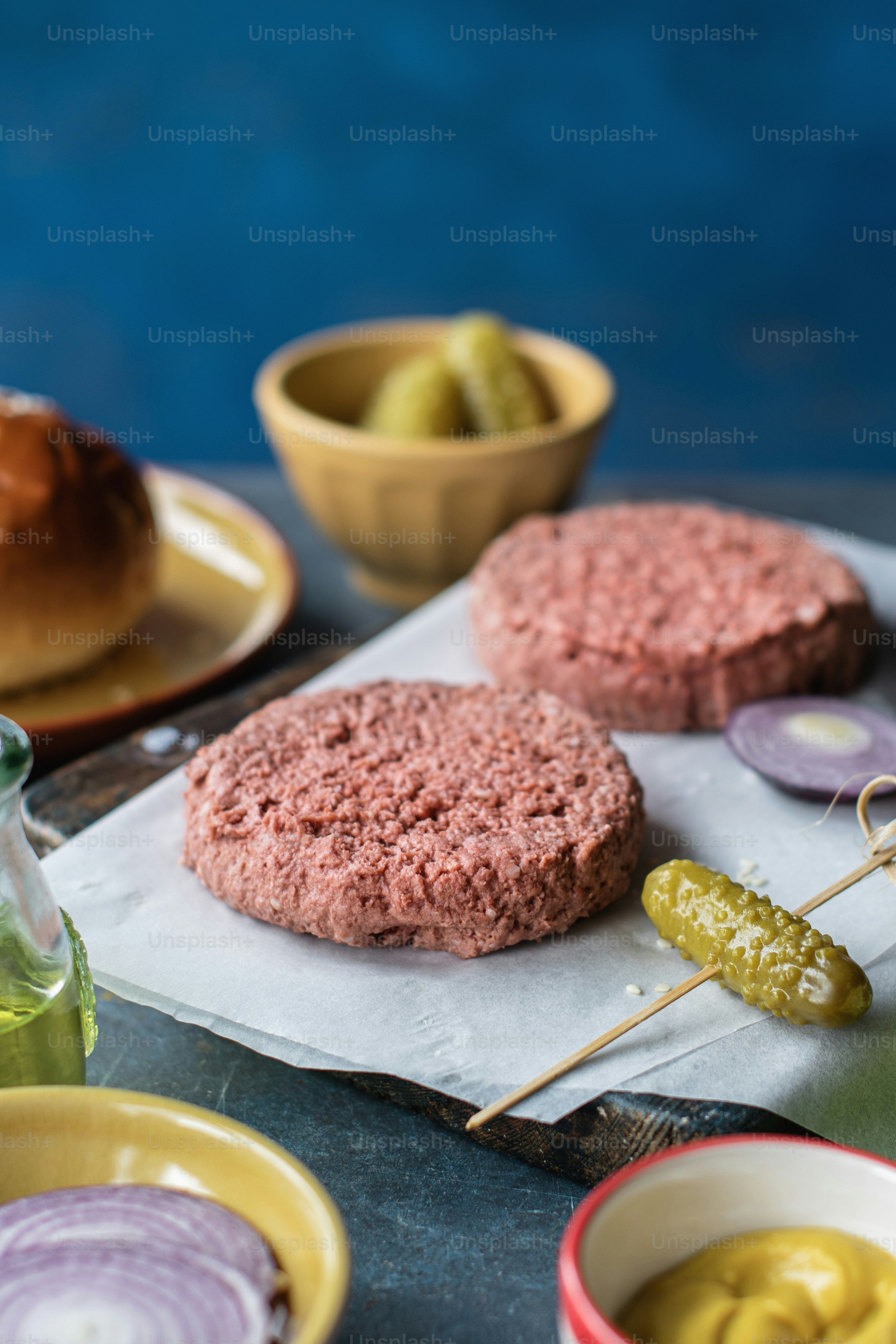 a hamburger with pickles and pickles on a skewer