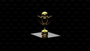 a golden trophy sitting on top of a table