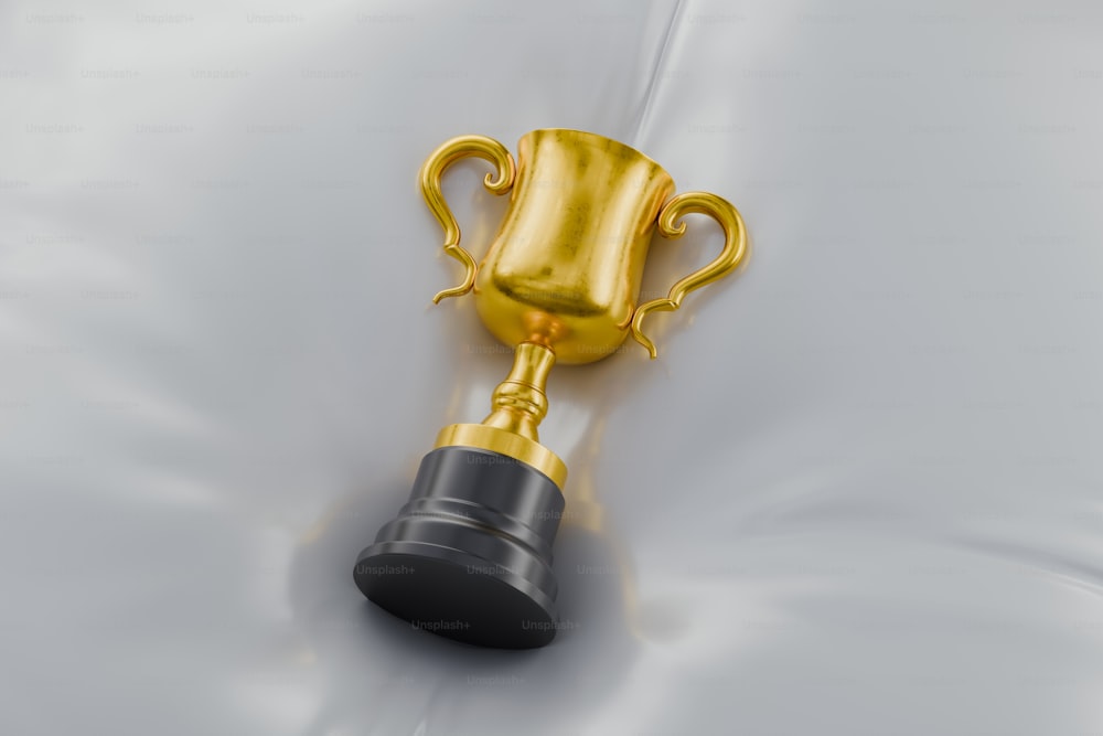 a golden trophy with a black base on a white background