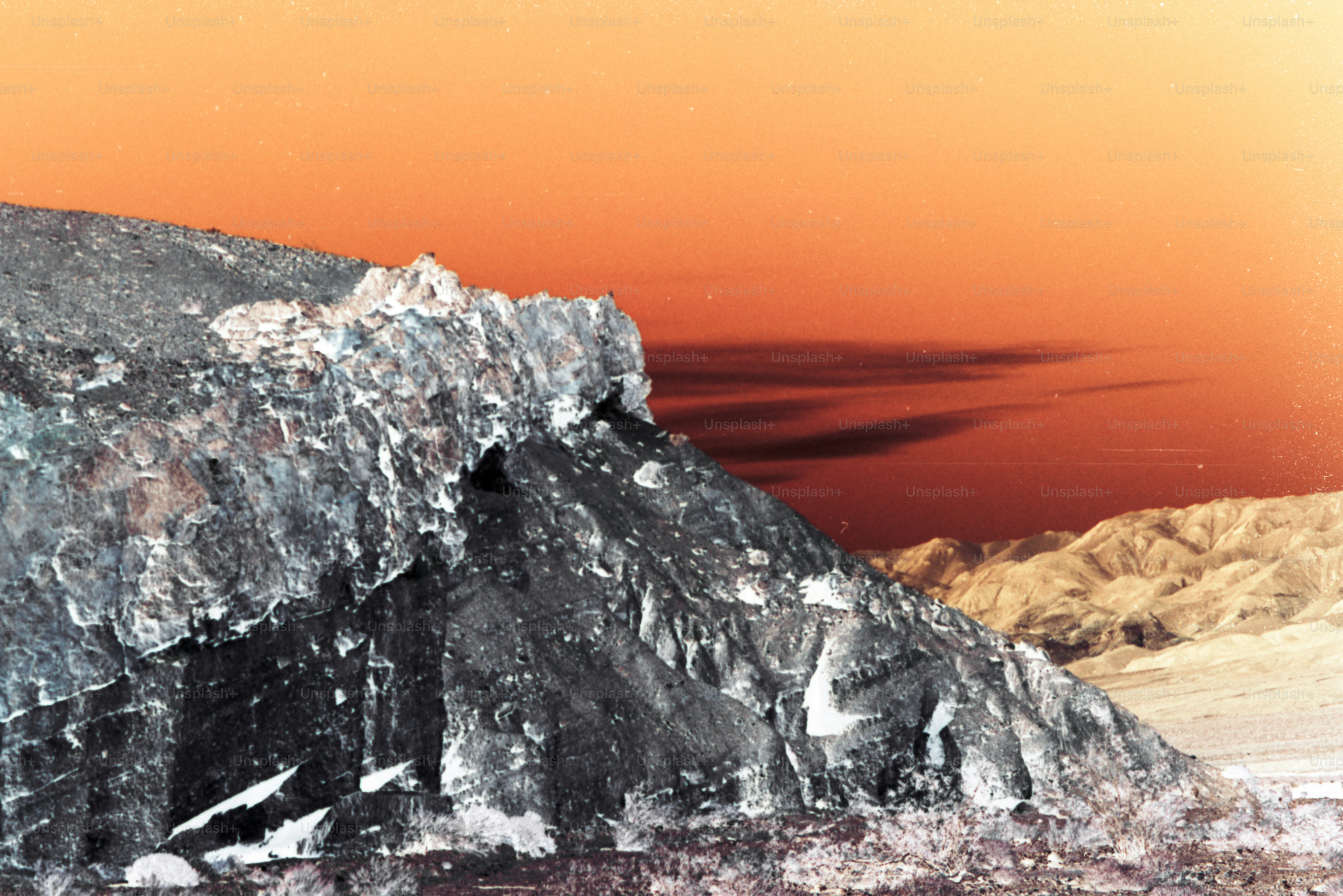 a snowboarder is jumping off of a mountain