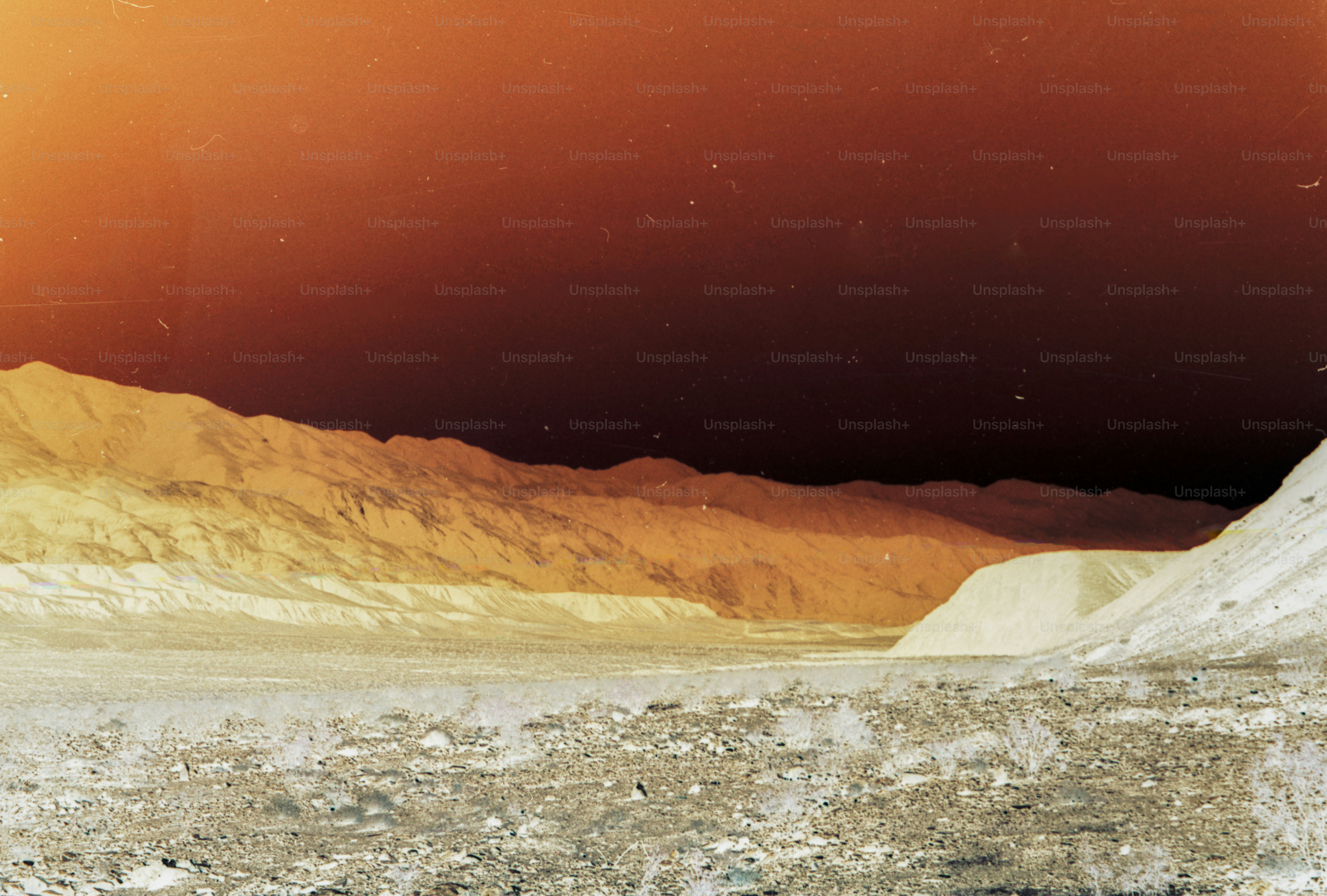 a man riding a snowboard down a snow covered slope