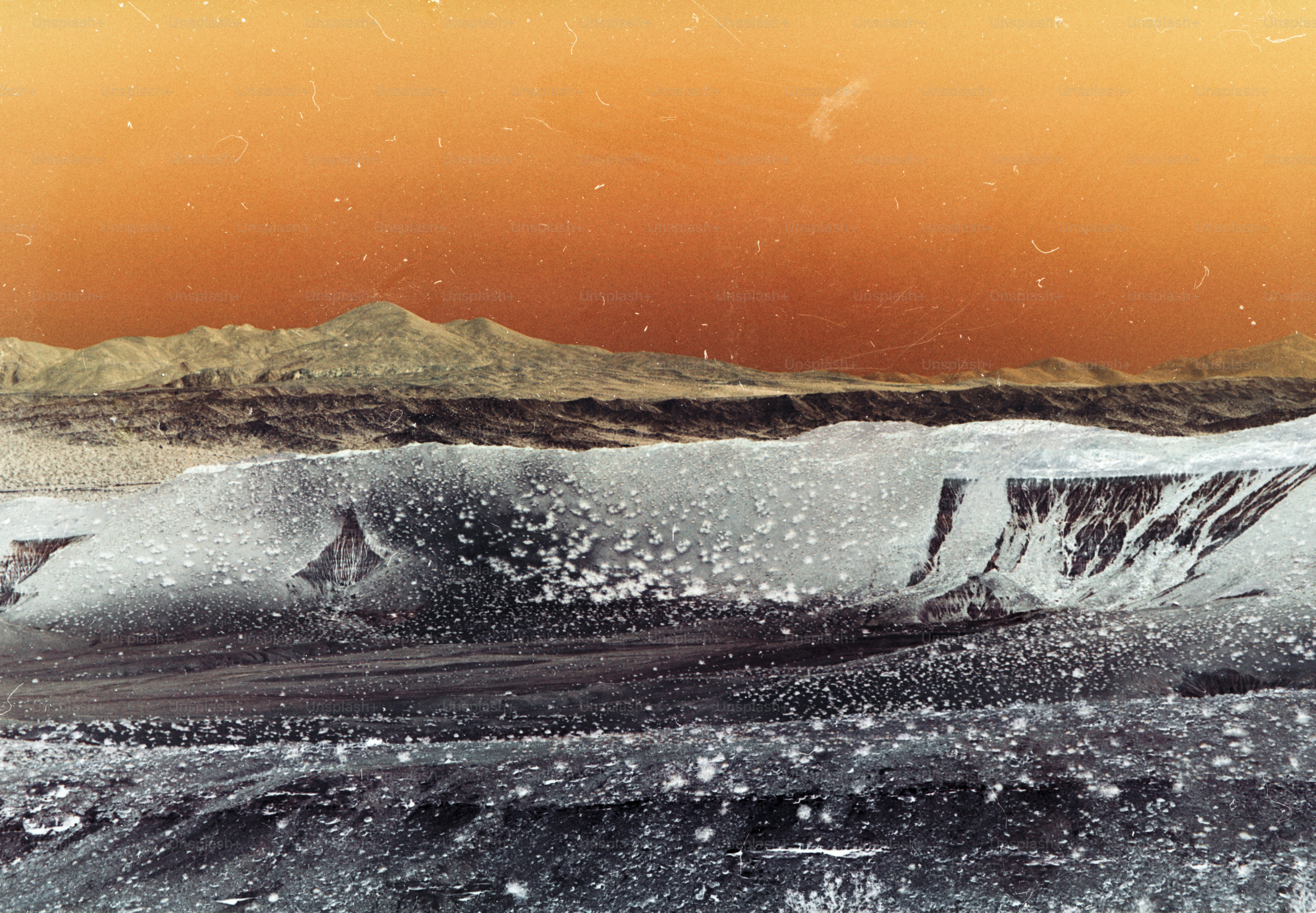 a man riding a snowboard down a snow covered slope