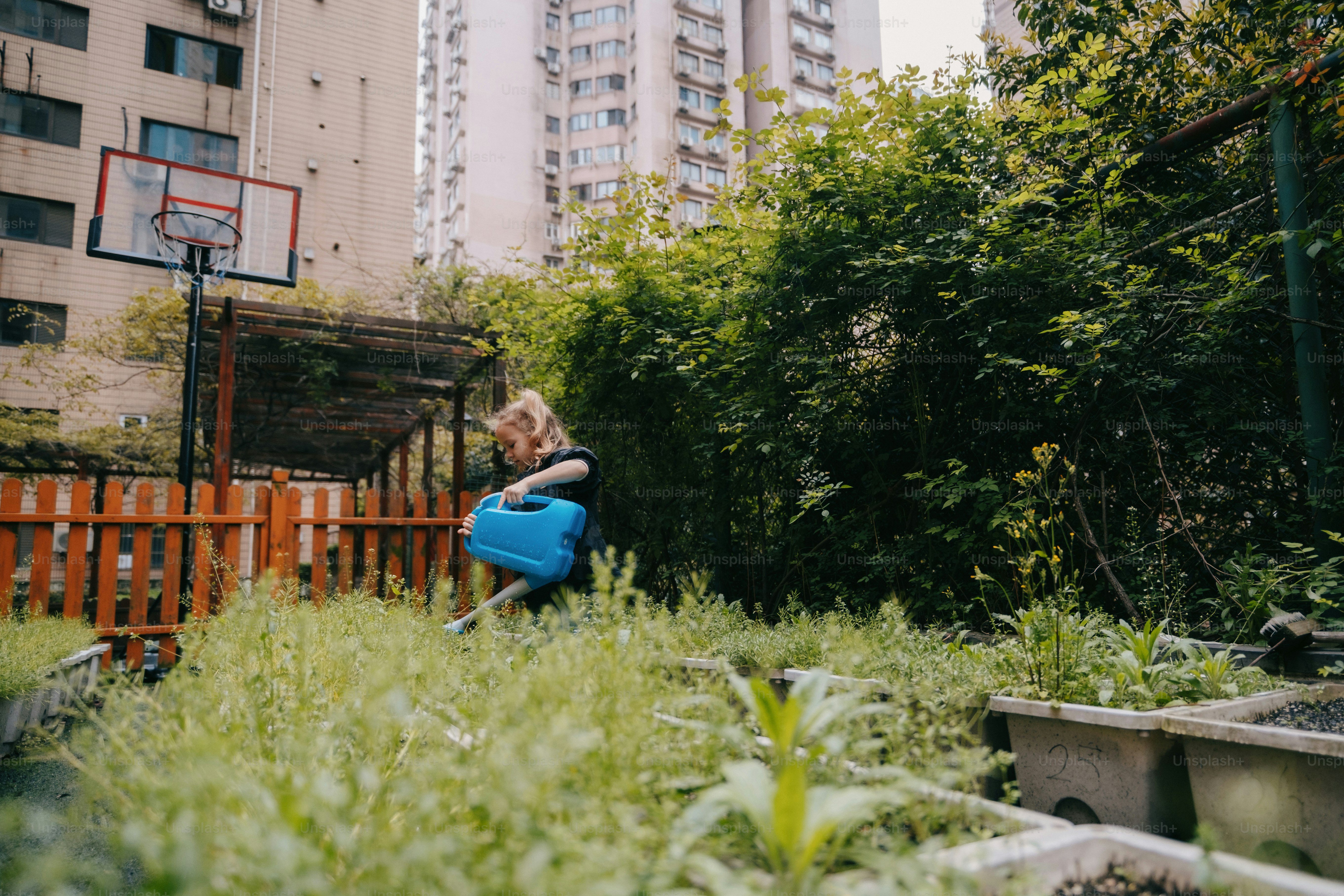 a woman is holding a blue watering can