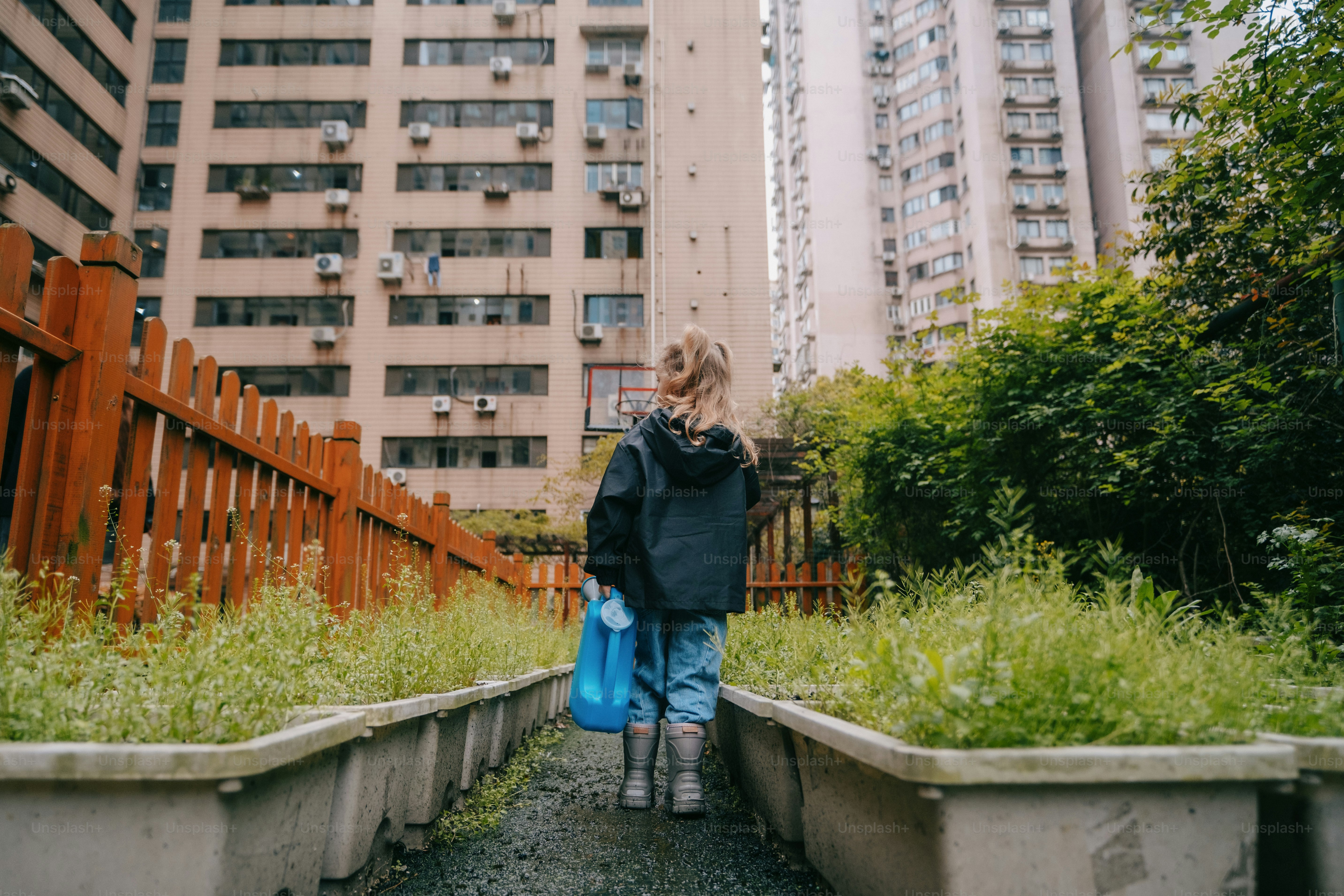 a woman with a blue bag walking down a path