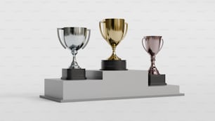 three trophies on a pedestal on a white background