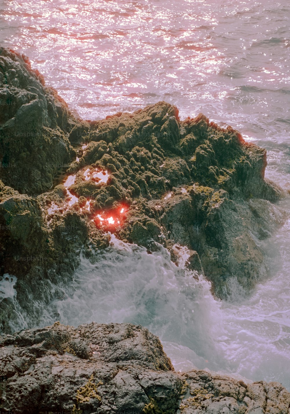 a rock formation with a red light in the middle of it