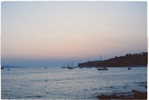 a group of boats floating on top of a body of water