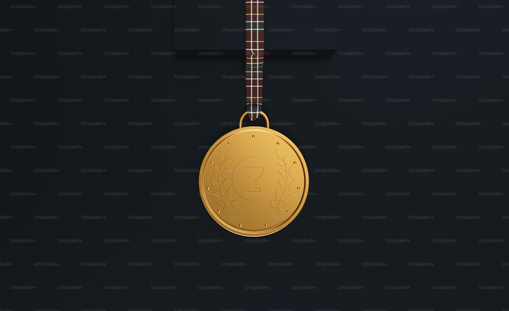a gold medal hanging on a black wall