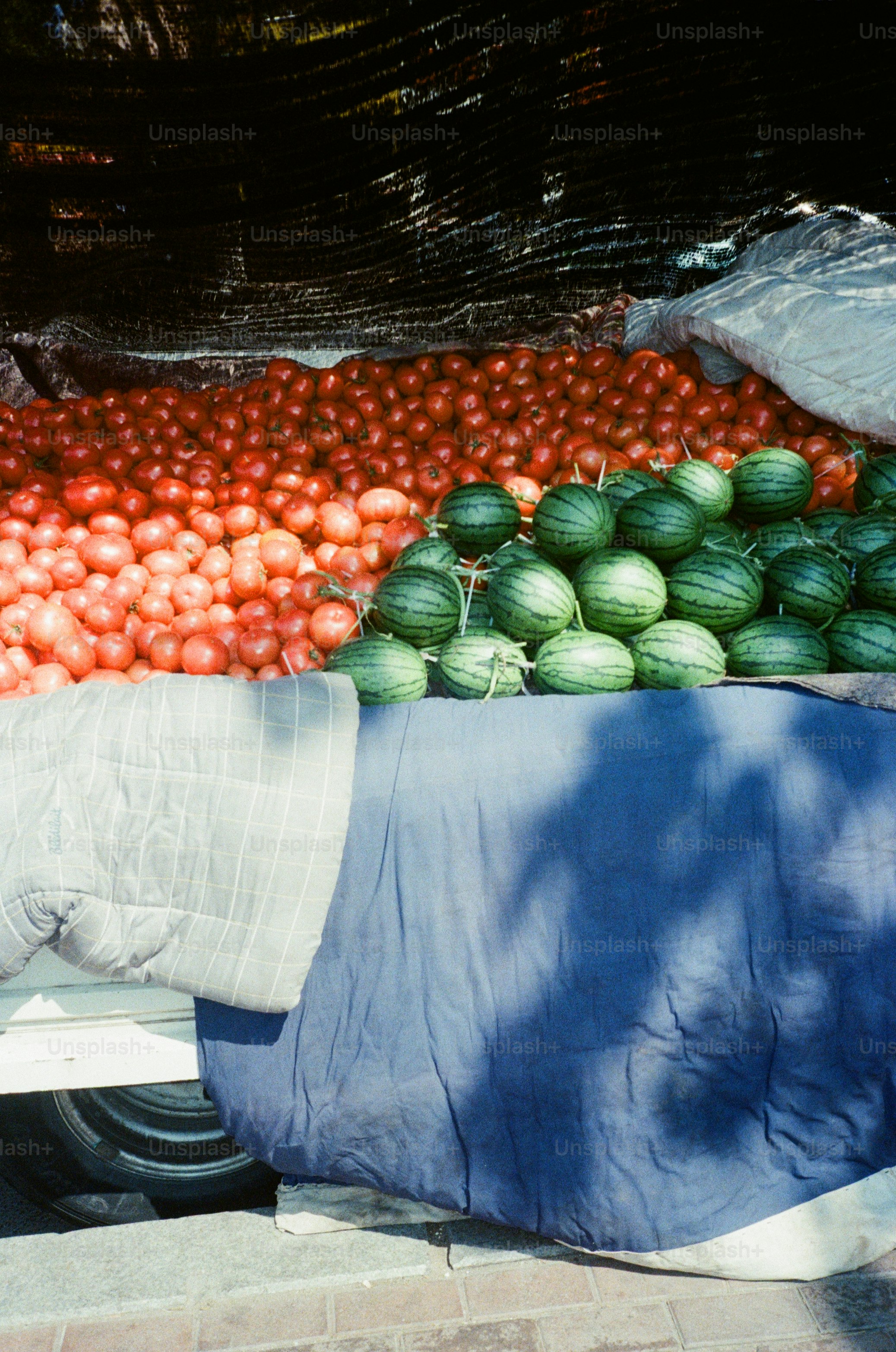 a pile of watermelons sitting on top of a table