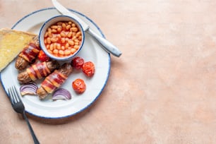 a plate of food that includes beans and bacon