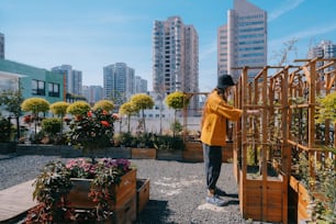 a person in a yellow jacket and some plants