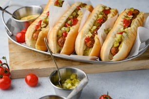 a tray of hot dogs with condiments on a table