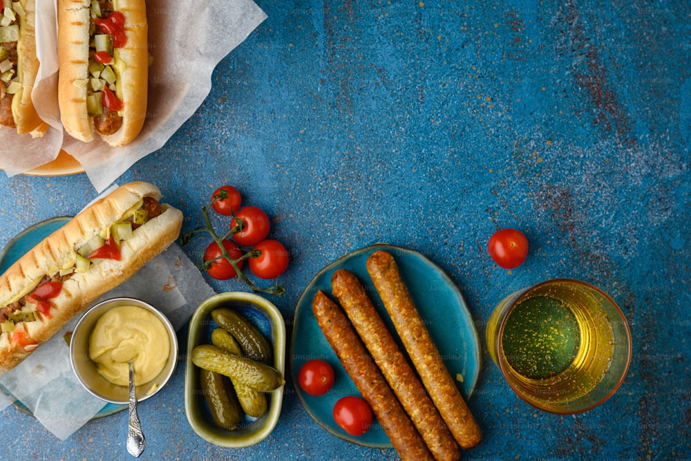 a table topped with hot dogs and pickles