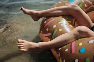 a person laying on an inflatable donut float