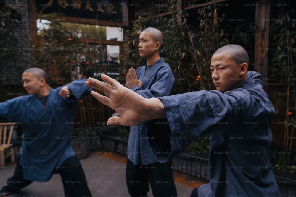 a group of men practicing martial moves in a courtyard