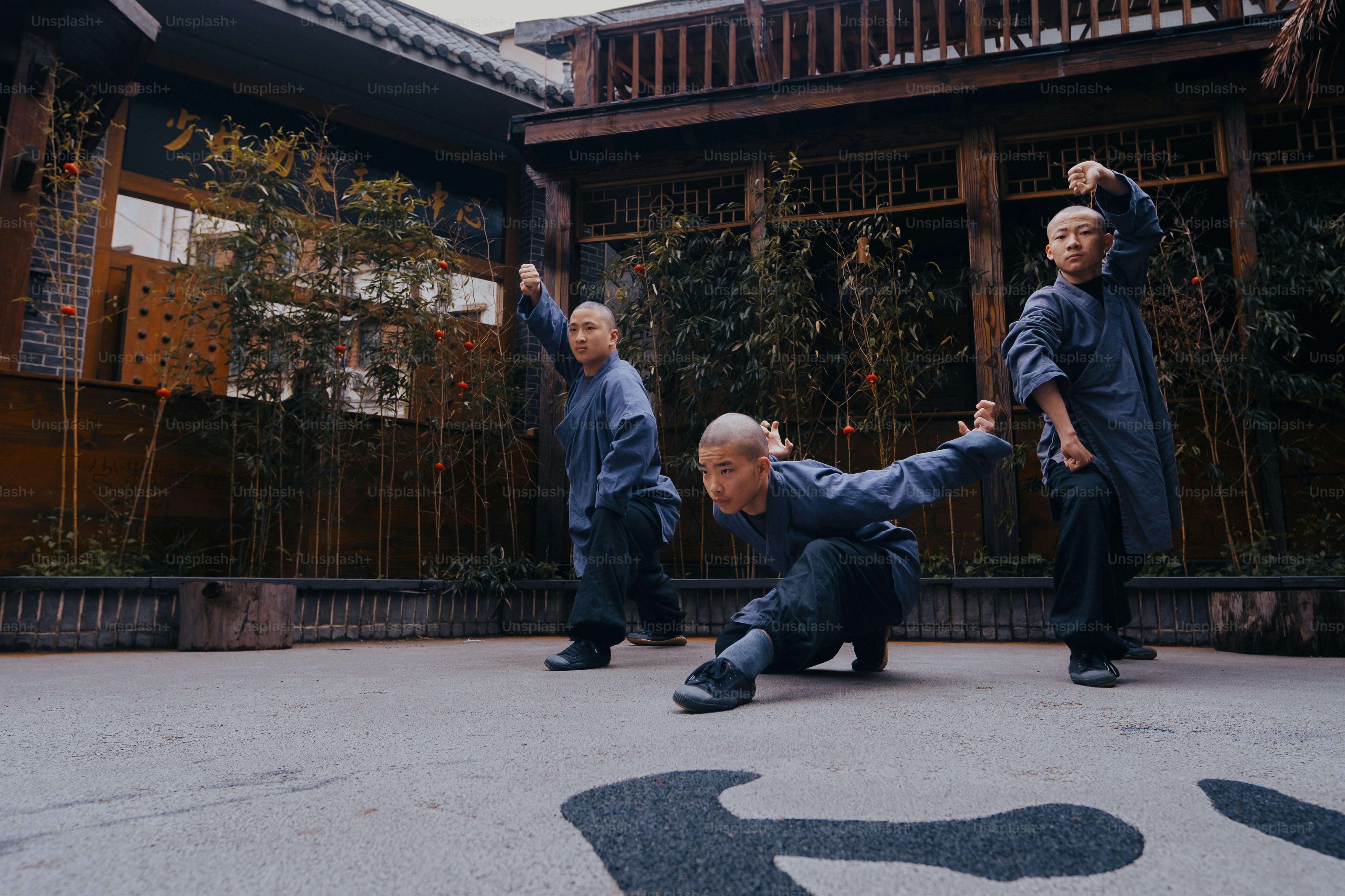 a group of men standing next to each other in front of a building