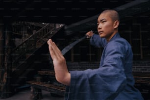 a man in a blue robe holding a knife