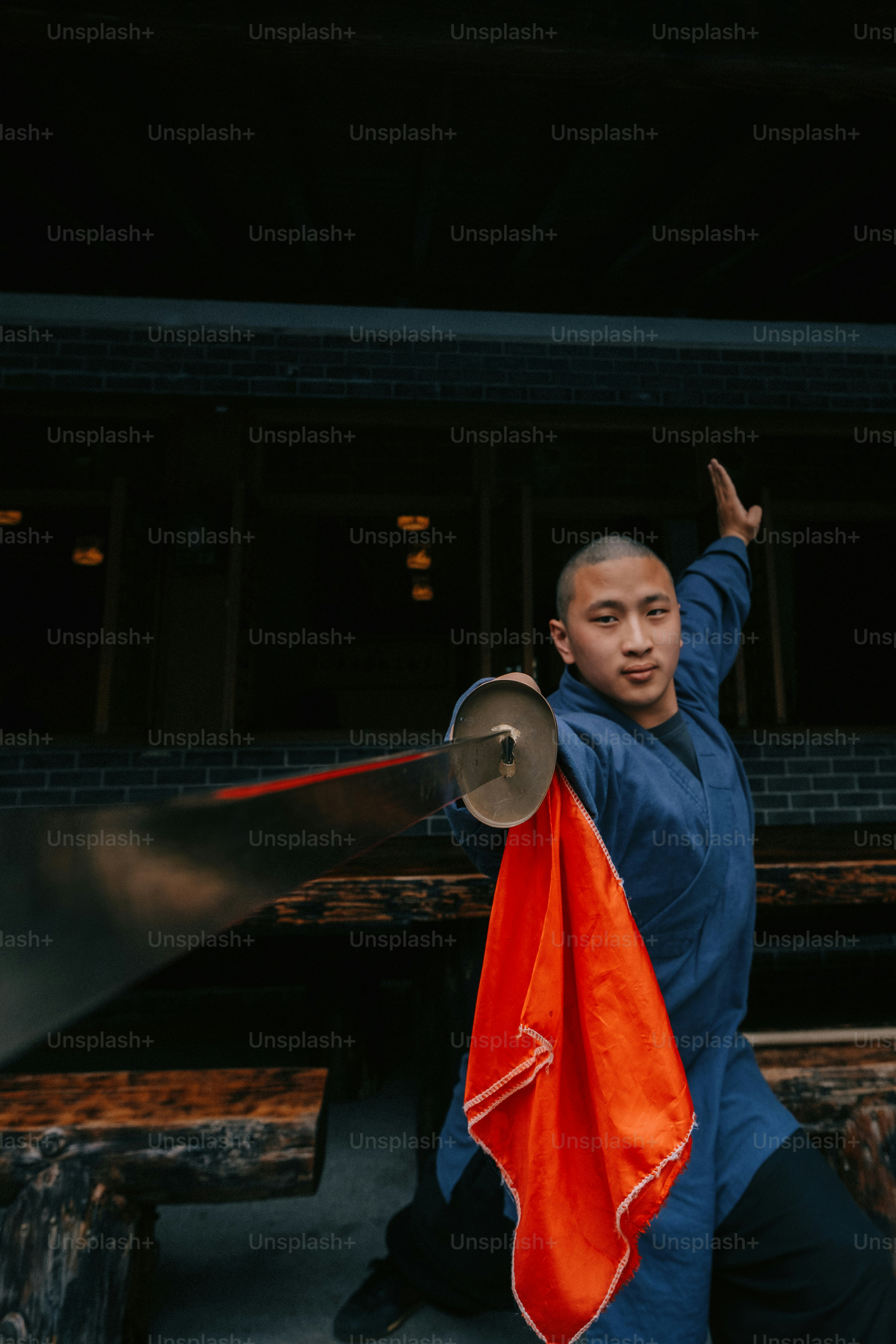 a man holding a red and orange flag