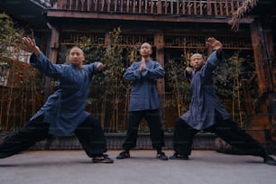 a group of men standing next to each other in front of a building