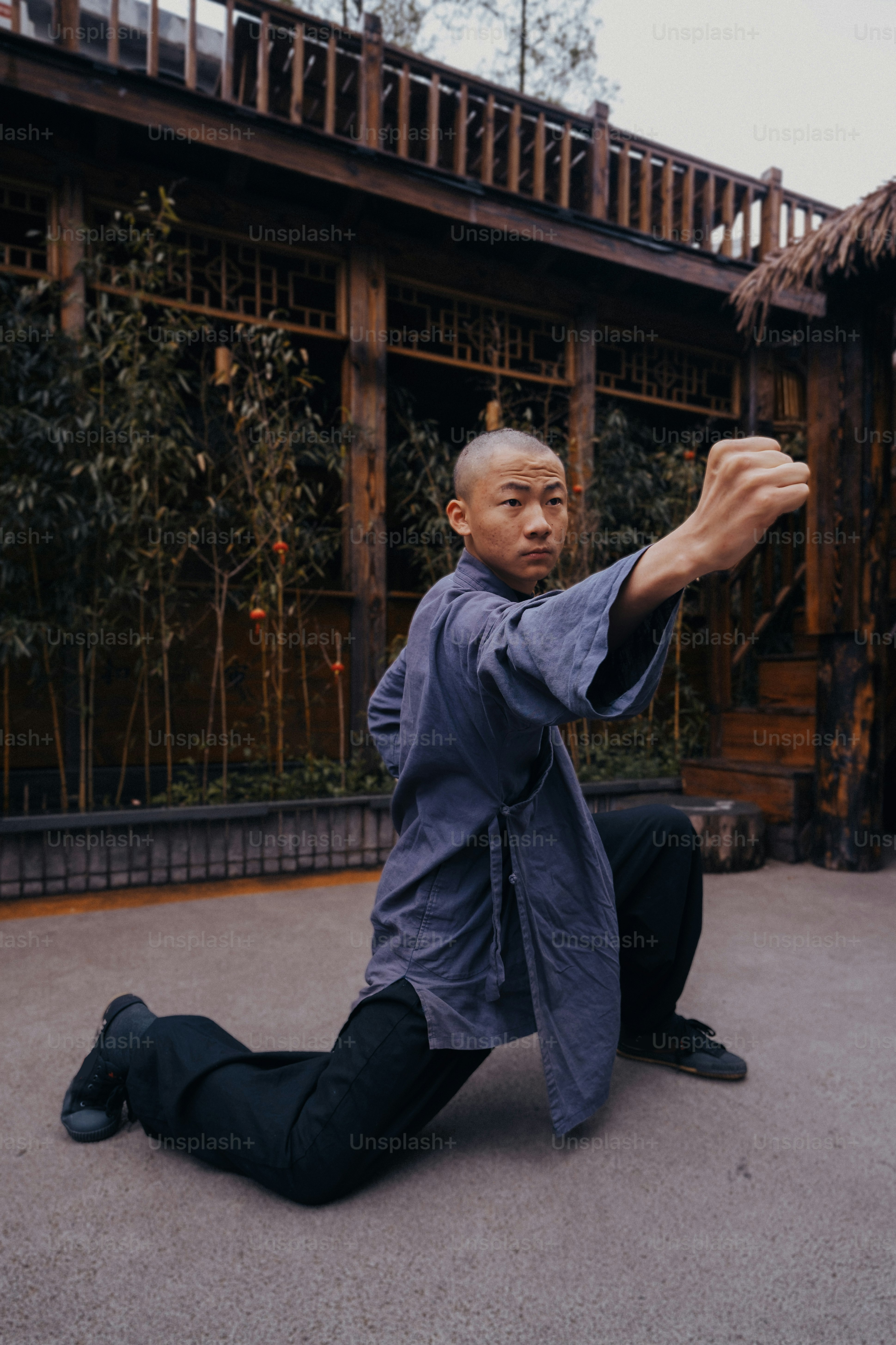 a man sitting on the ground in front of a building