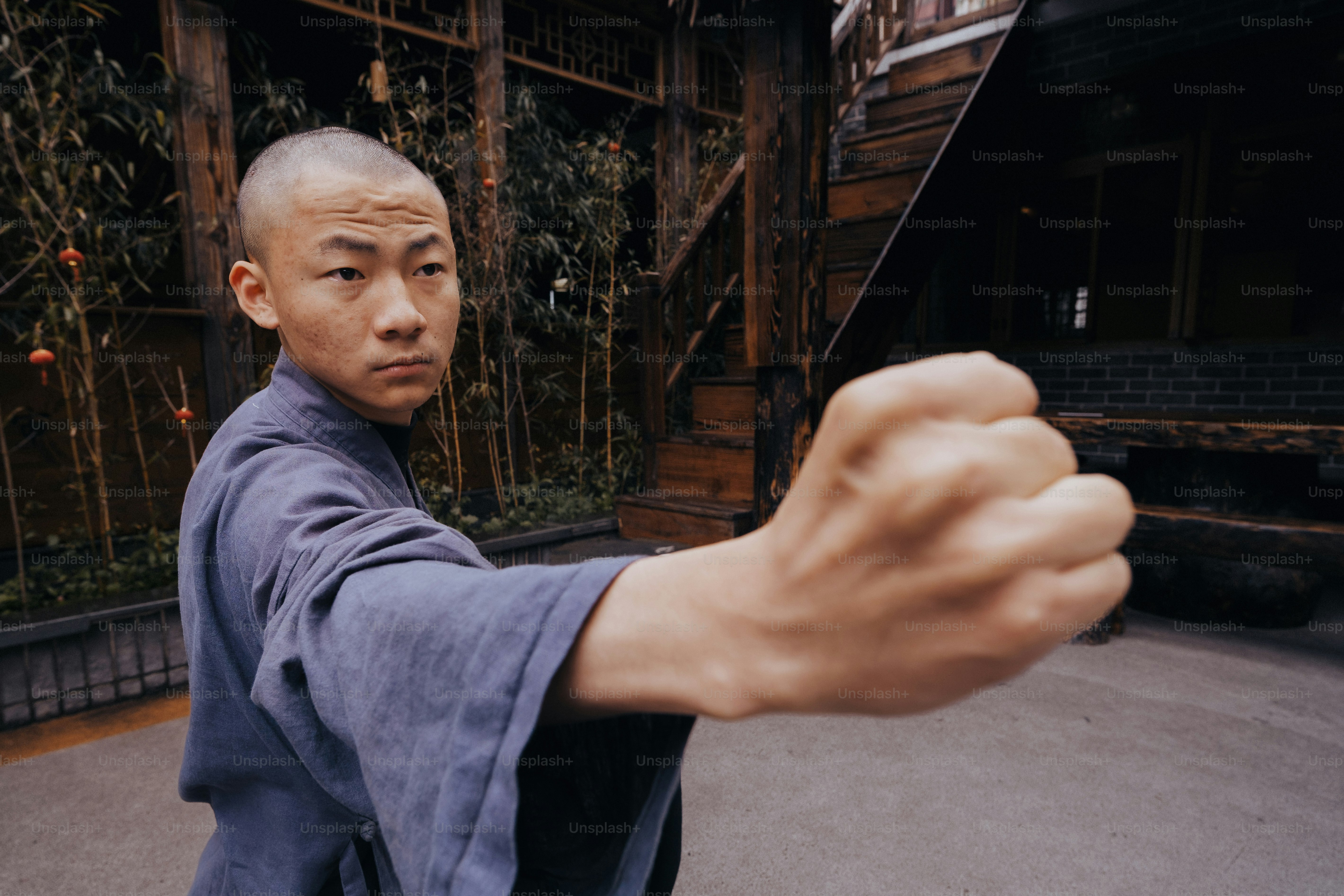 a man in a blue robe pointing a gun