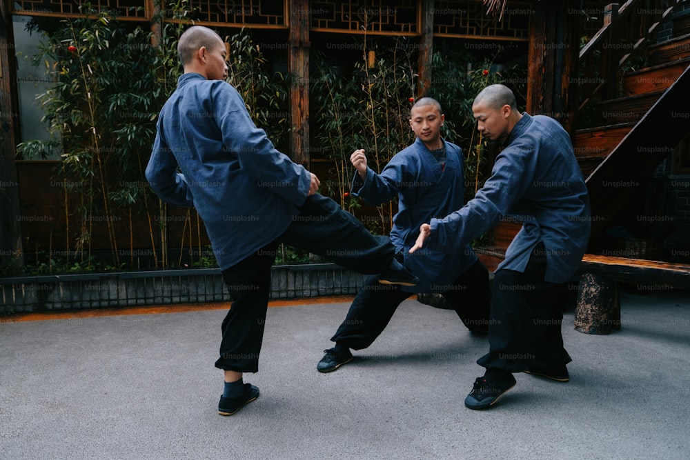 a group of men practicing martial moves in a courtyard