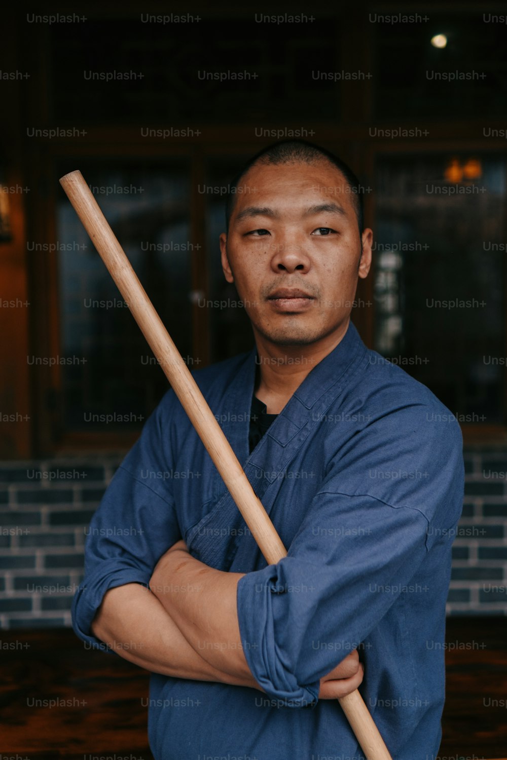 a man with a baseball bat standing in front of a building