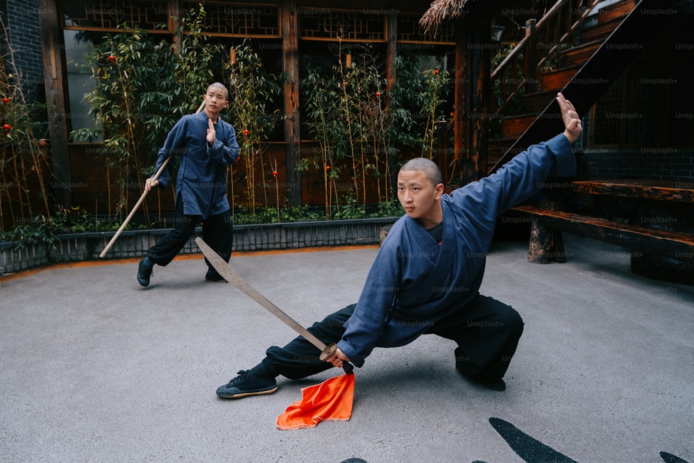 a man holding a sword in front of another man