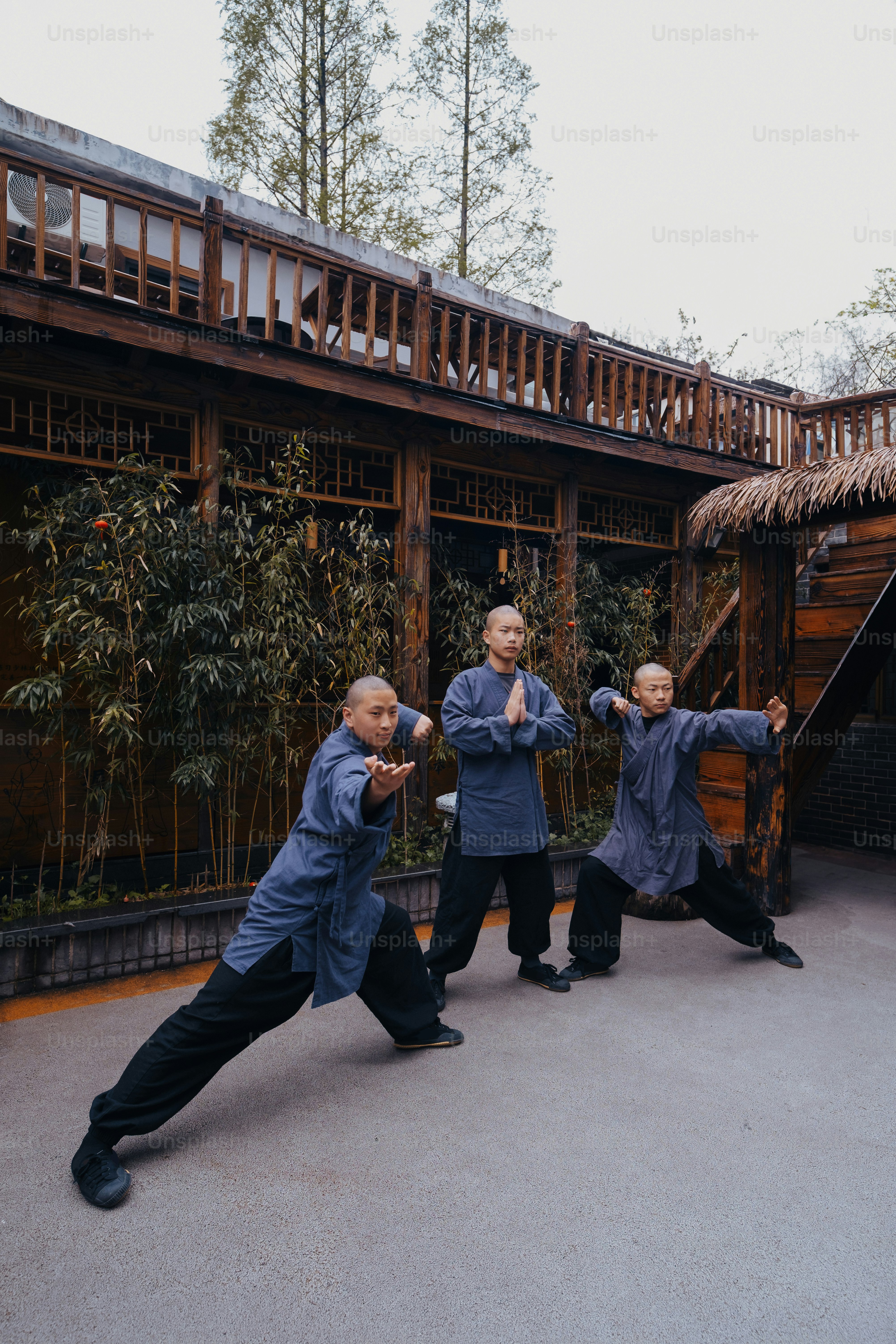 a group of men standing next to each other in front of a building