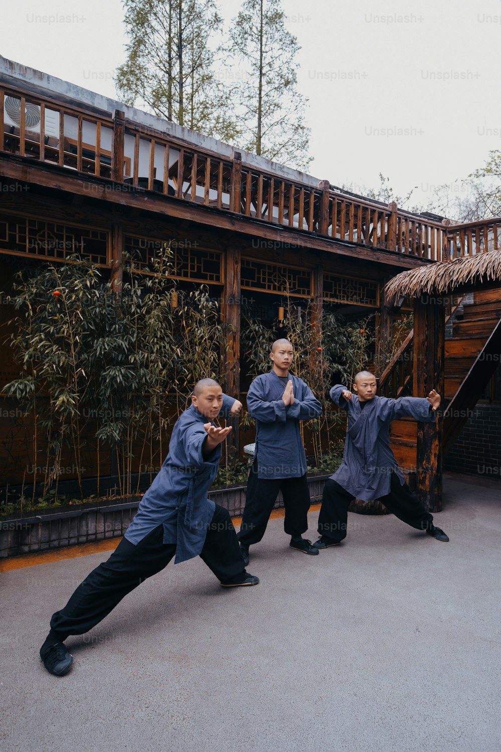 a group of men standing next to each other in front of a building