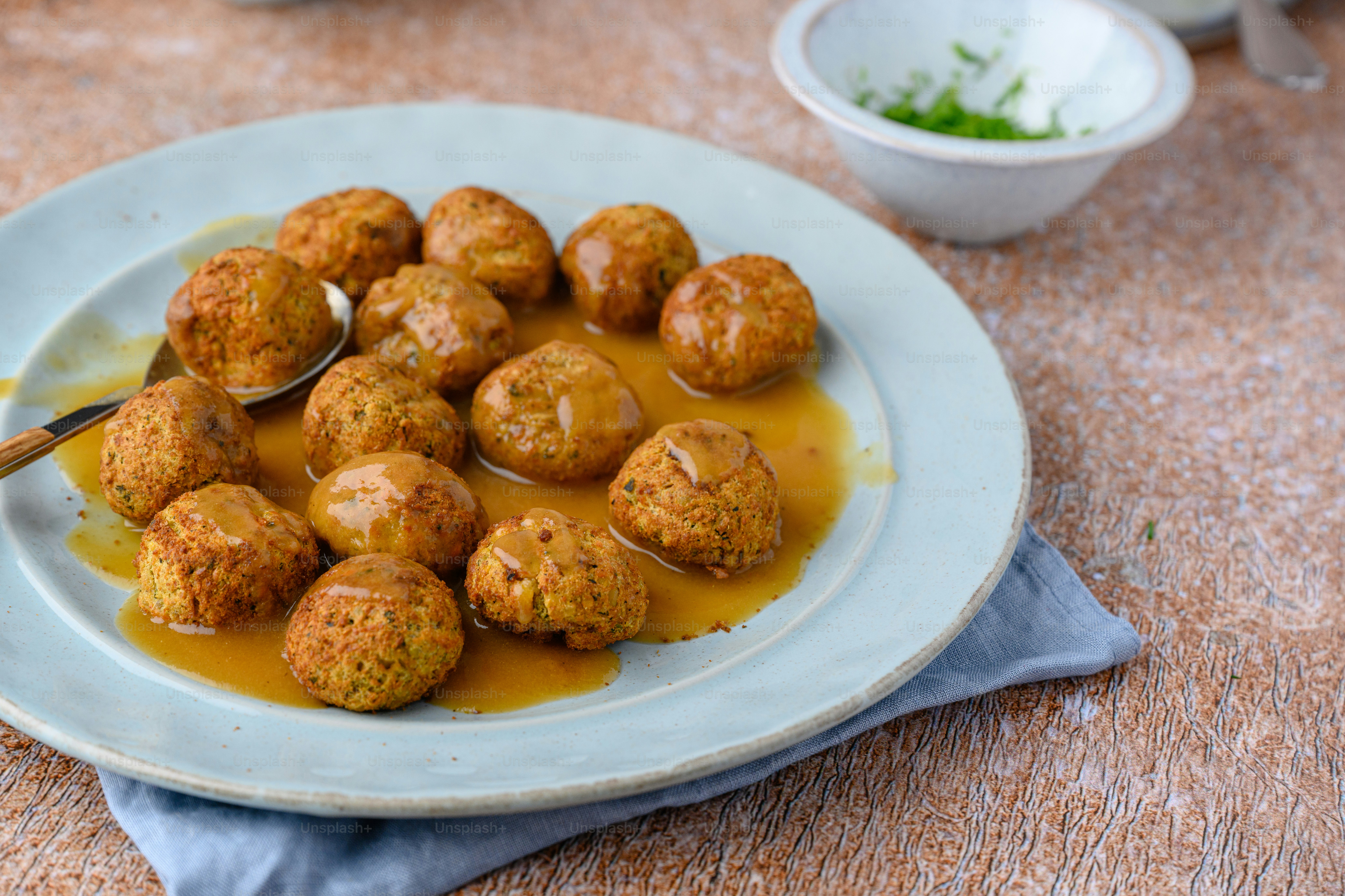 a white plate topped with meatballs covered in gravy