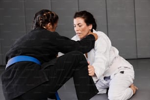 a woman sitting on the ground with another woman