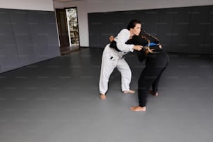 two people in a room with a black belt