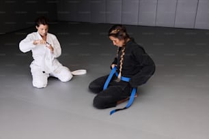 a woman sitting on the floor next to another woman