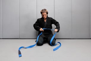 a woman sitting on the floor with a blue ribbon